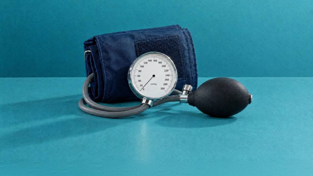 A blood pressure cuff with its dial gauge and inflation bulb