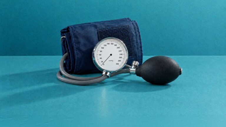 A blood pressure cuff with its dial gauge and inflation bulb