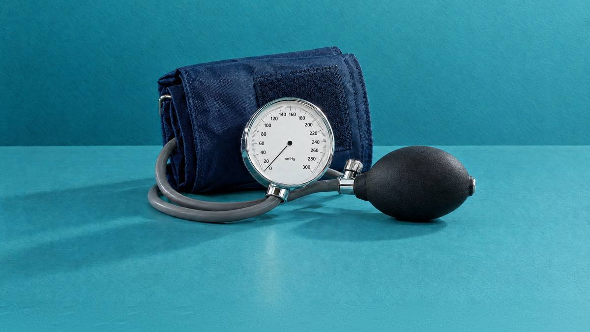 A blood pressure cuff with its dial gauge and inflation bulb