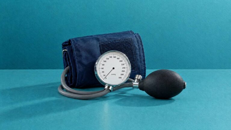 A blood pressure cuff with its dial gauge and inflation bulb