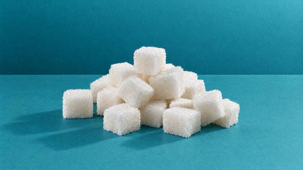 A small, loose pile of white sugar cubes